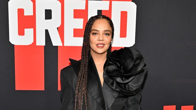 Actress Tessa Thompson in a black dress on the red carpet of 'Creed III'