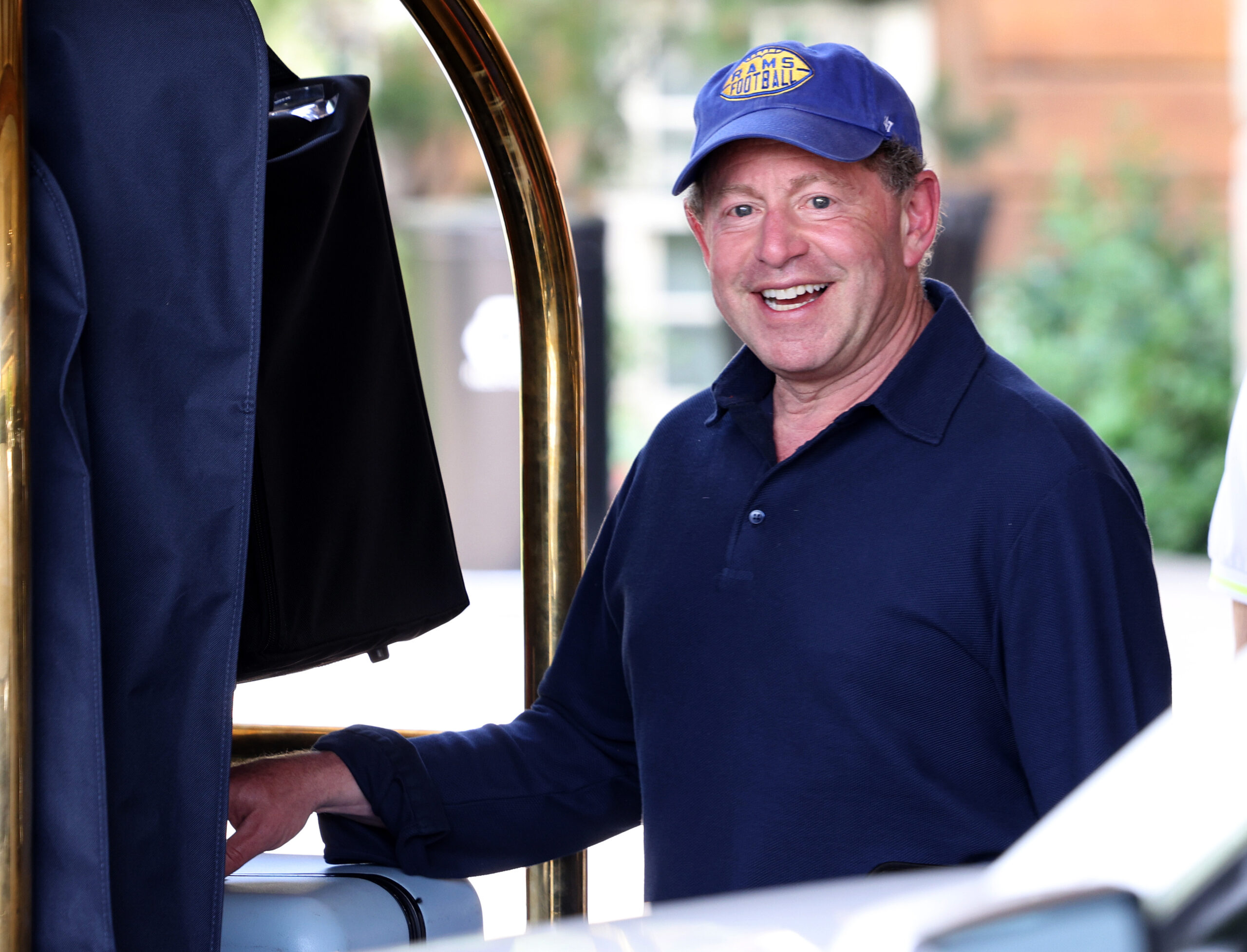 CEO Bobby Kotick smiles facing the camera wearing a baseball cap.