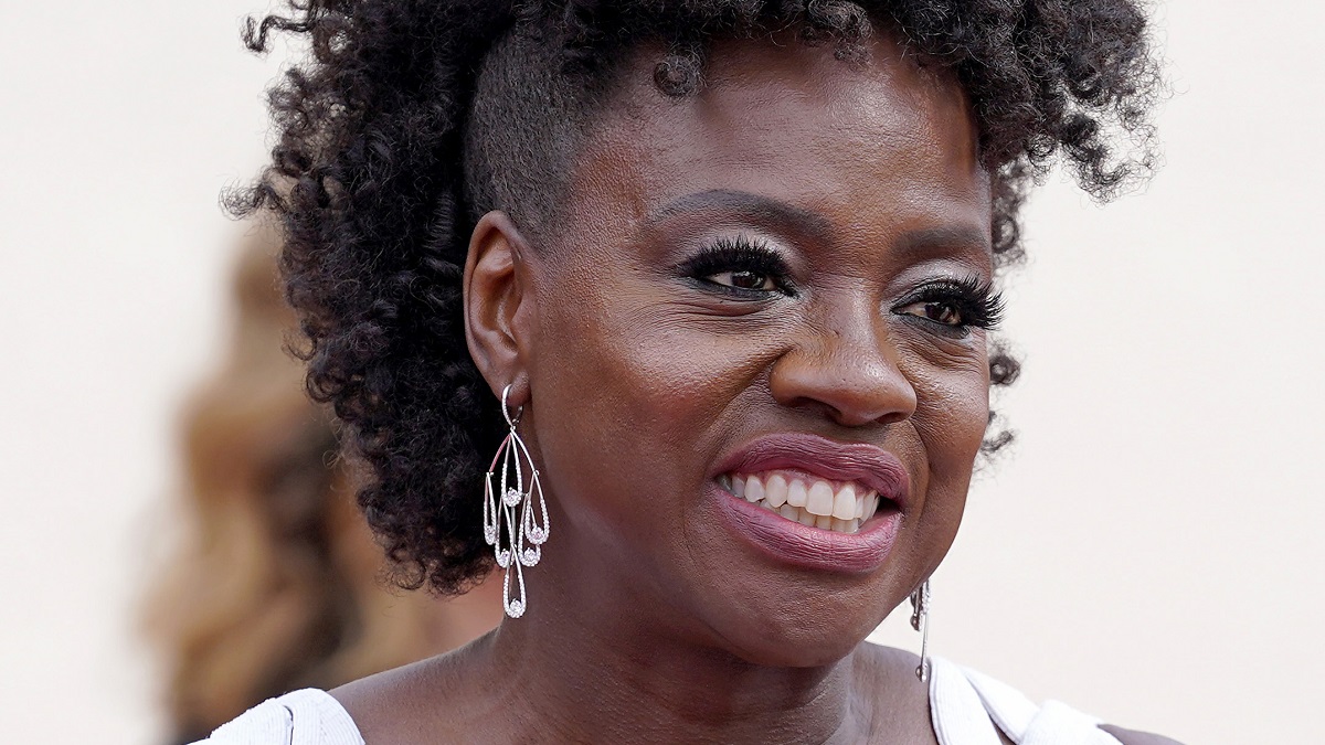 A photo of Viola Davis wearing pink lipstick and spectacular earrings