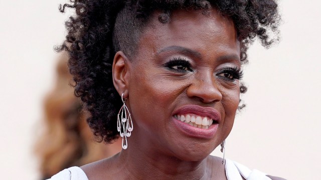 A photo of Viola Davis wearing pink lipstick and spectacular earrings