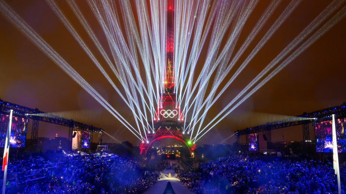 Overview of the Trocadero venue, with the Eiffel Tower looming in the background and lasers lighting up the sky, during the opening ceremony of the Paris 2024 Olympic Games on July 26, 2024 (Photo by François-Xavier Marit - Pool/Getty Images)