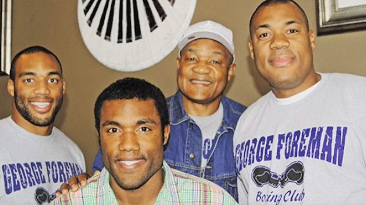George Foreman is posing with some of his sons. 
