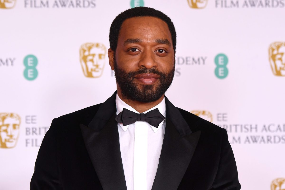 Chiwetel Ejiofor in a tuxedo looking at the amera