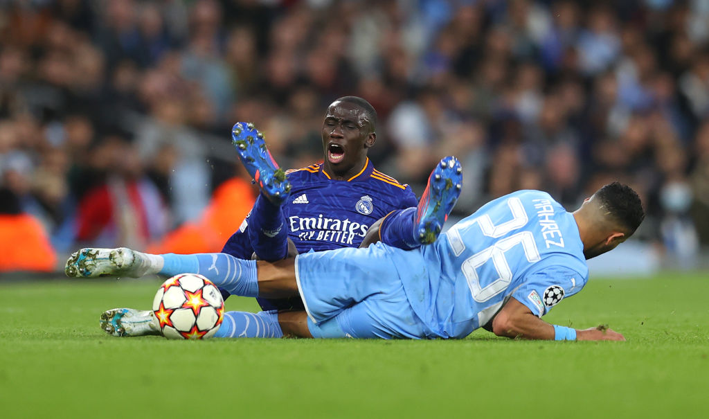 Ferland Mendy of Real Madrid clashes with Riyad Mahrez of Manchester City.