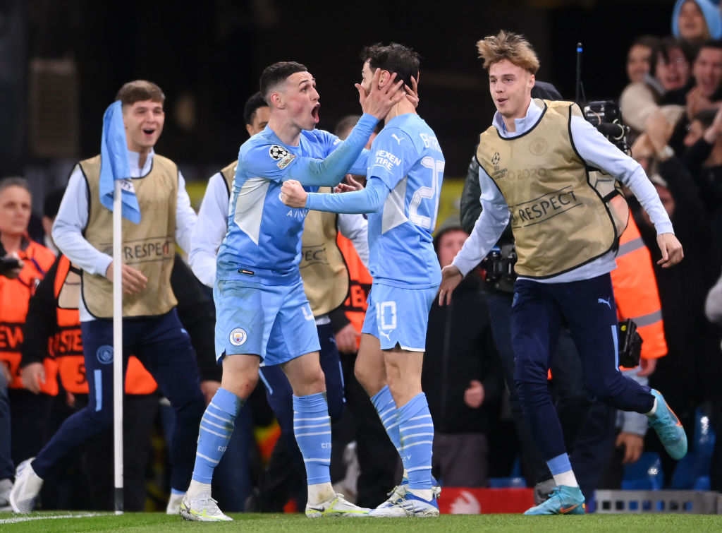 Bernardo Silva of Manchester City celebrates with Phil Foden after a goal.