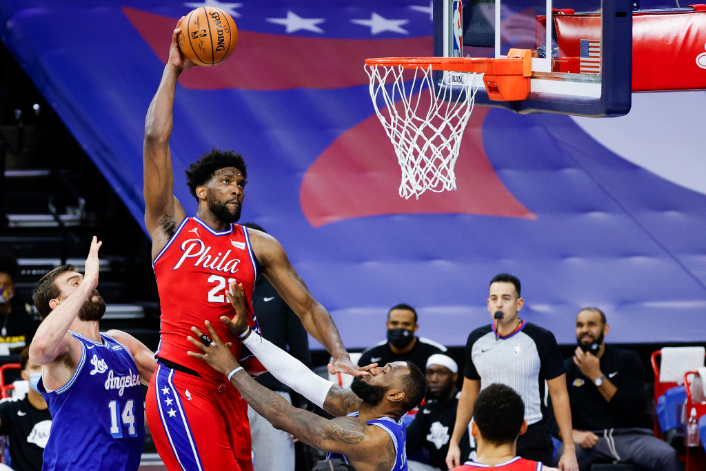 The Philadelphia 76ers' Joel Embiid goes up for a dunk over LeBron James of the Los Angeles Lakers.