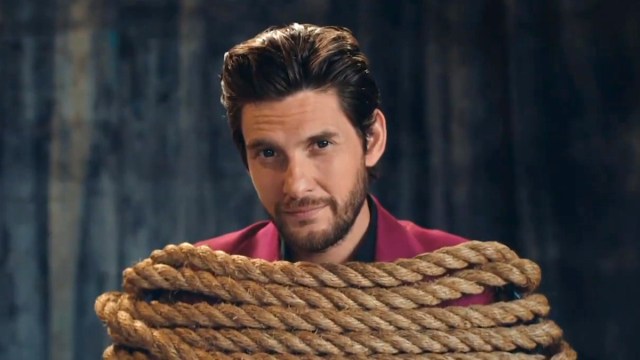 Ben Barnes in a T-Mobile commercial, wrapped within a pile of rope while looking dead into the camera with a mild smirk