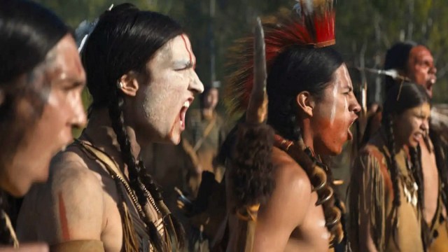 Cast members in character as Comanche warriors shouting in a still from ‘Prey’