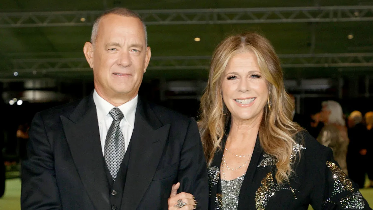 Tom Hanks and Rita Wilson walking arm-in-arm in formal wear.