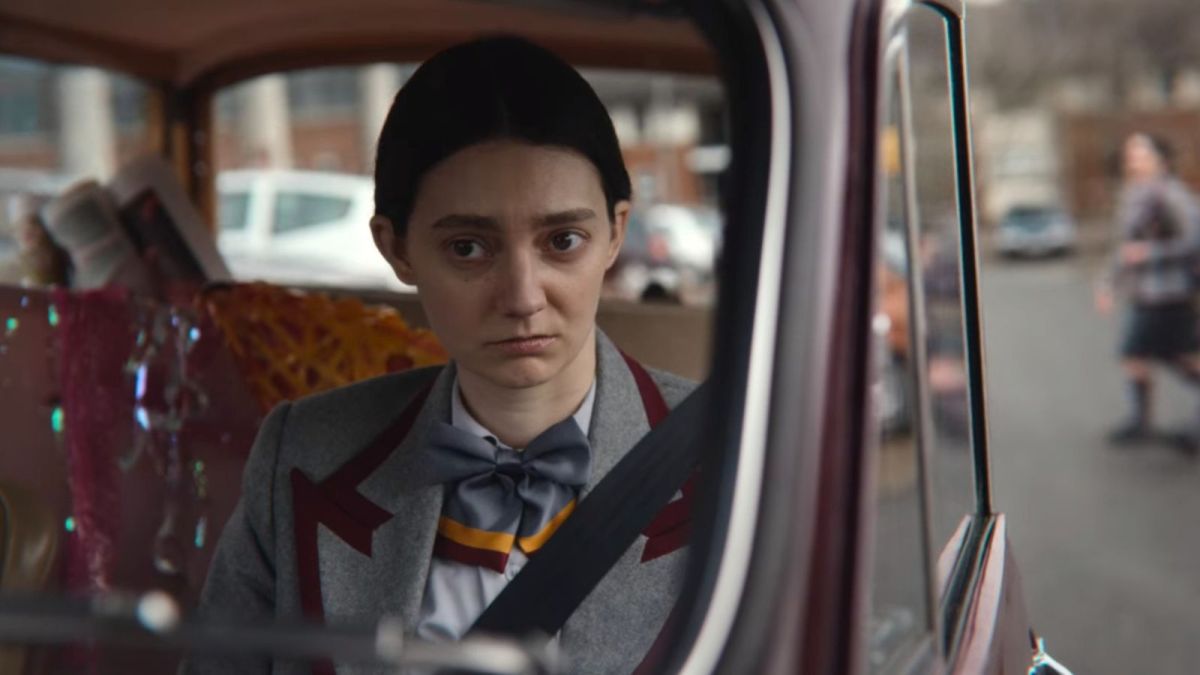 Lily (Tanya Reynolds) looks glum in the backseat of a car in 'Sex Education' season 3