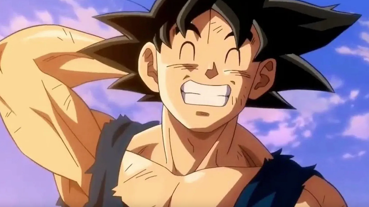 Goku is smiling and holding his arm behind his head.