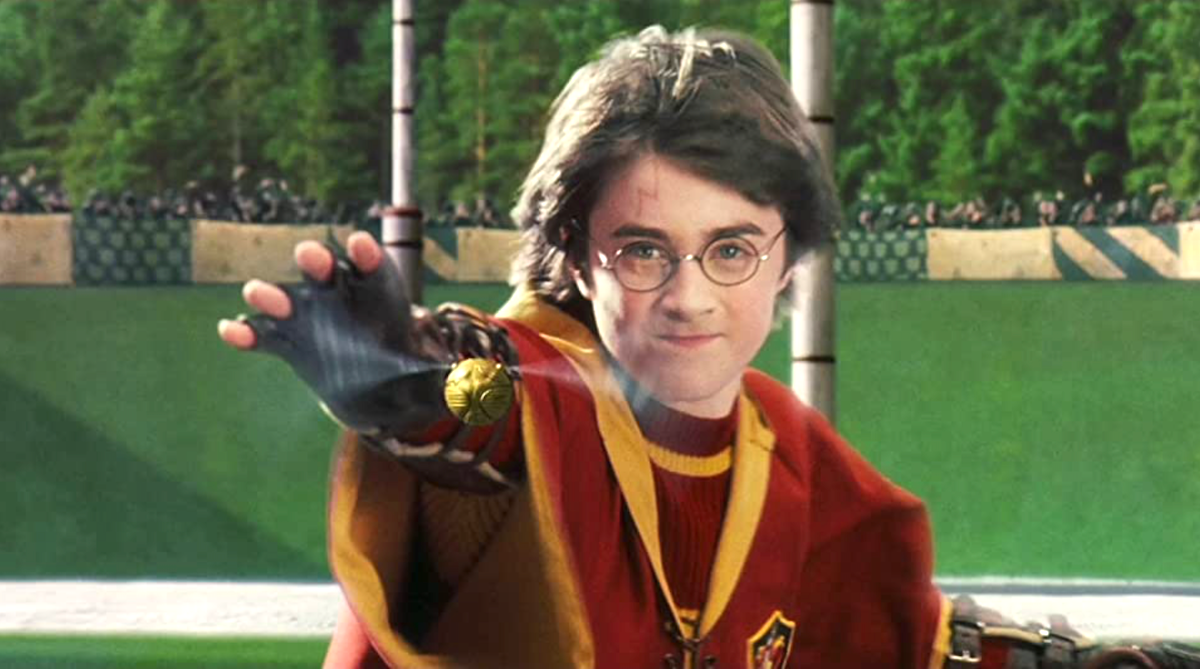 Daniel Radcliffe catches the Snitch in 'Harry Potter and the Sorcerer's Stone'