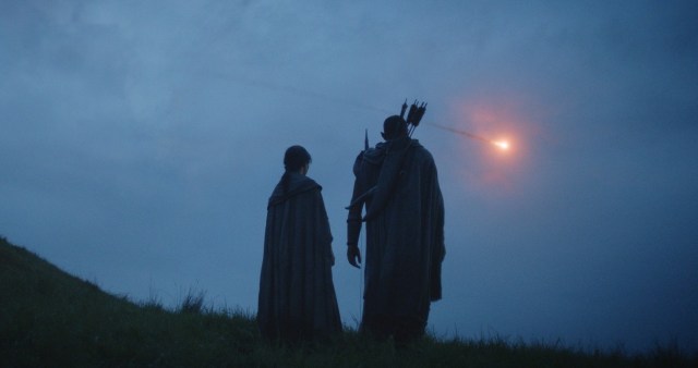Two silhouette figures of elves against the night sky in “Rings of Power”