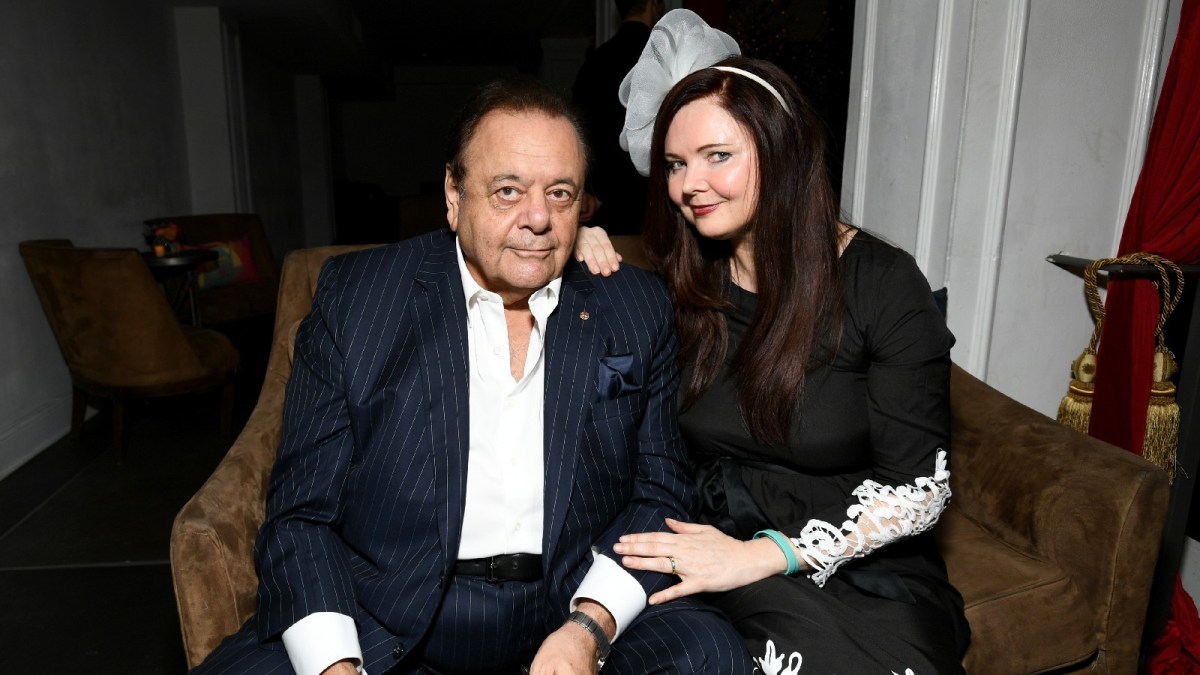 Paul Sorvino and Dee Dee Sorvino pose together while in formal wear sitting on a couch.