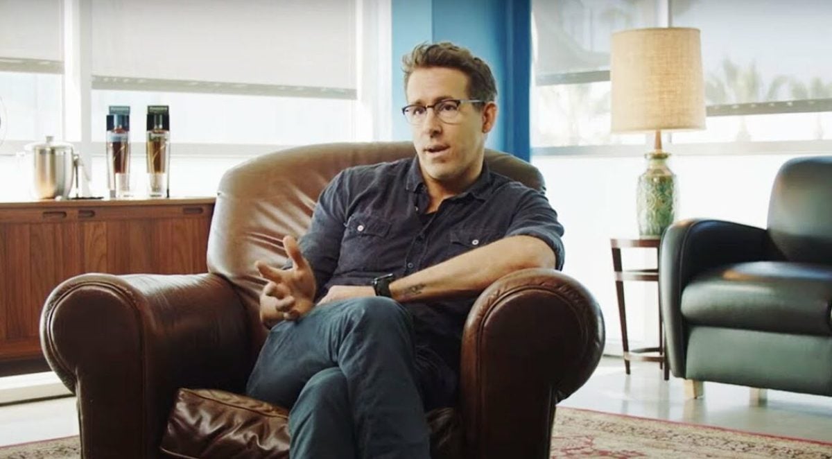 Ryan Reynolds sits in a chair for an interview in 'Welcome to Wrexham.'