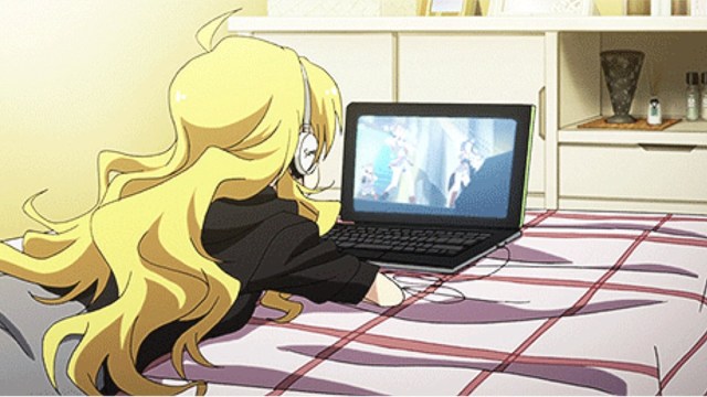 Miki Hoshii from 'The Idolmaster' watching video on a laptop.