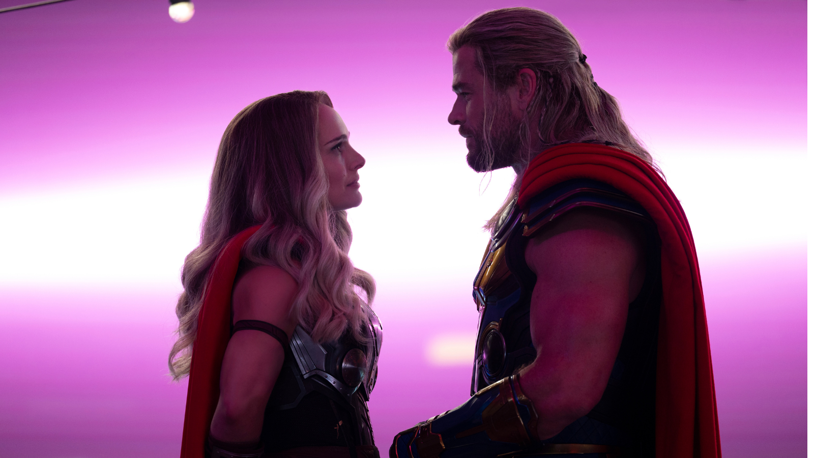 Natalie Portman as Mighty Thor and Chris Hemsworth as Thor face each other in a romantic silhouette from ‘Thor: Love and Thunder’