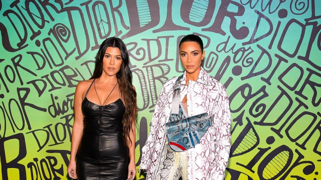 Kourtney Kardashian and Kim Kardashian Pose at an event