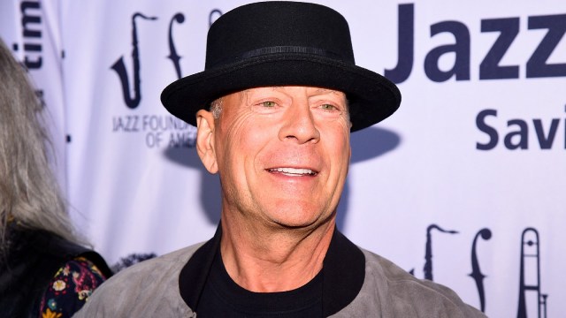 Bruce Willis sports a flat-top cap at a jazz music event.