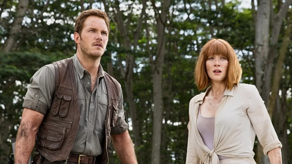 Chris Pratt and Bryce Dallas Howard in character looking astonished in a still from “Jurassic World:Dominion”