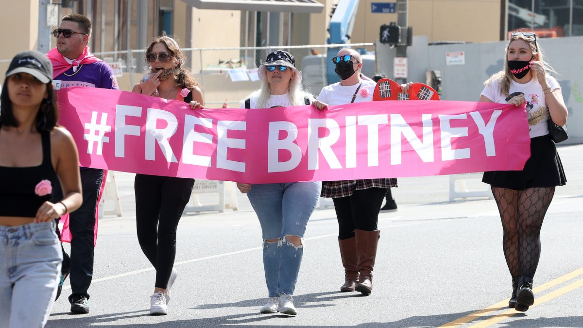#FreeBritney activists protest during a rally, holding a #FreeBritney banner