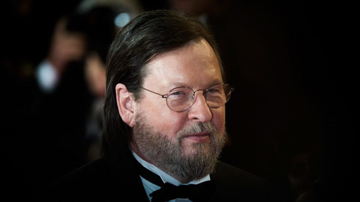 Lars von Trier in glasses and a formal collar and tie
