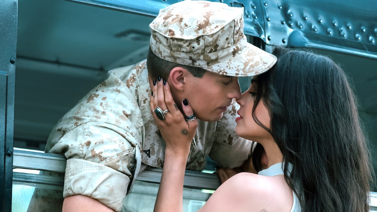 Nicholas Galitzine's character Luke in army uniform kissing Sofia Carson's character Cassie