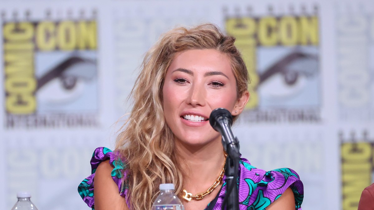 Dichen Lachman speaks at a panel at Comic Con
