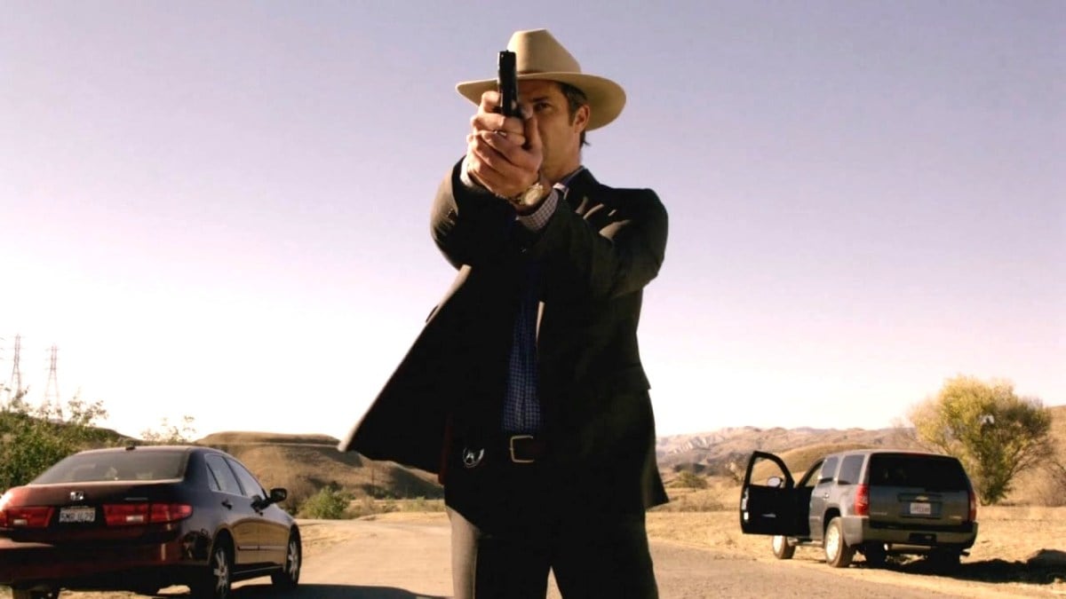 Timothy Olyphant in character as Raylan Givens, aiming a gun in a still from “Justified: City Primeval”