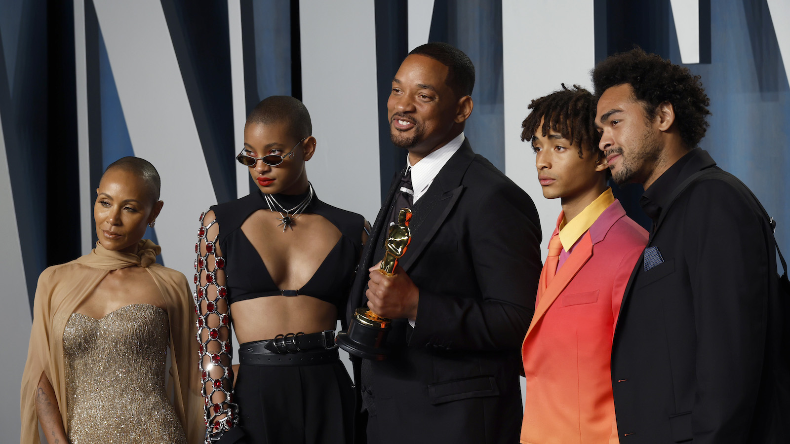 Will Smith holds Academy Award statue accompanied by wife Jada Pinkett and children Willow, Jaden, and Trey on the red carpet of the Vanity Fair Oscar party.