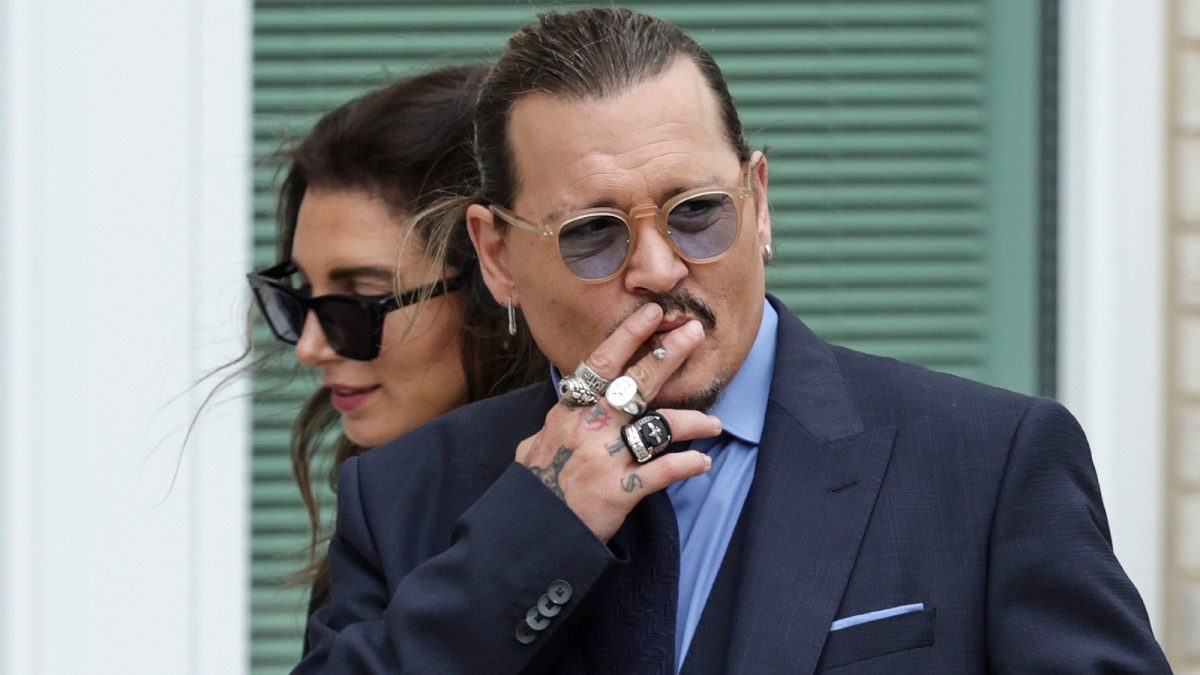 Actor Johnny Depp smokes during a break in his trial at a Fairfax County Courthouse on May 27, 2022 in Fairfax, Virginia.