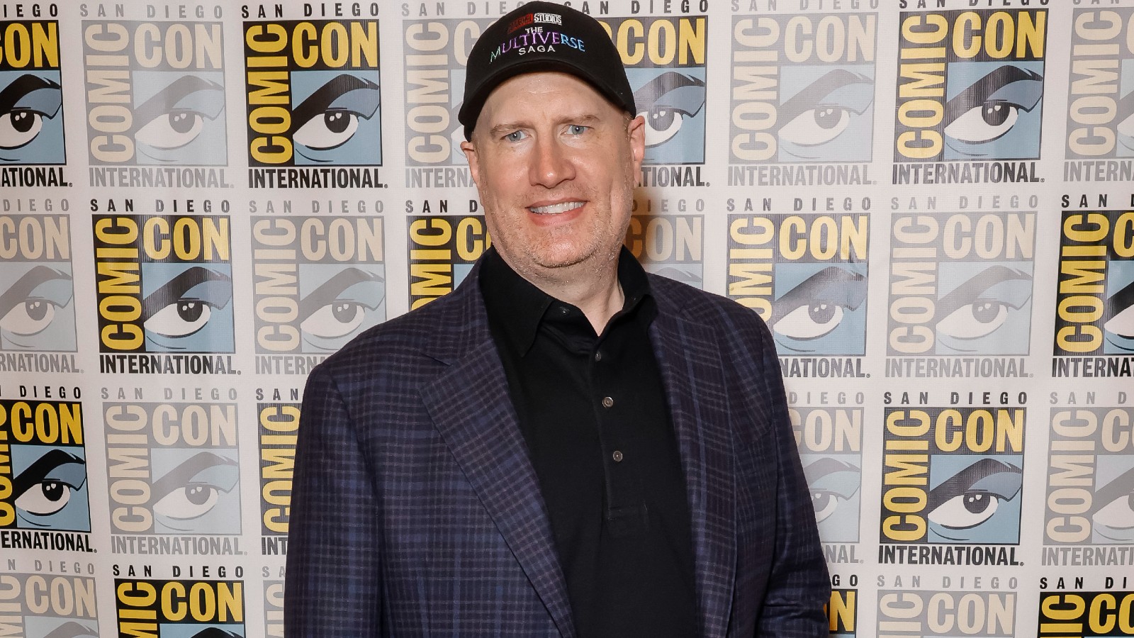 Kevin Feige wears a purple blazer and ballcap at Sand Diego Comic-Con.
