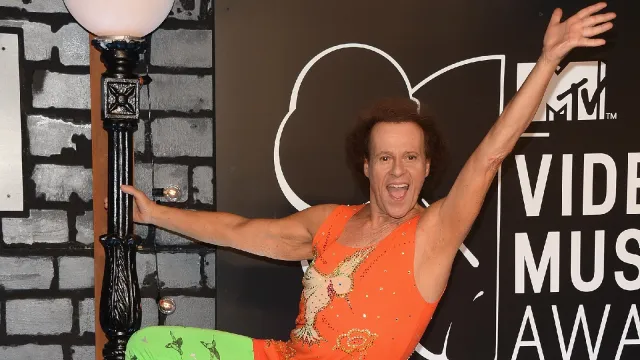 Richard Simmons strikes a pose on a red carpet event.
