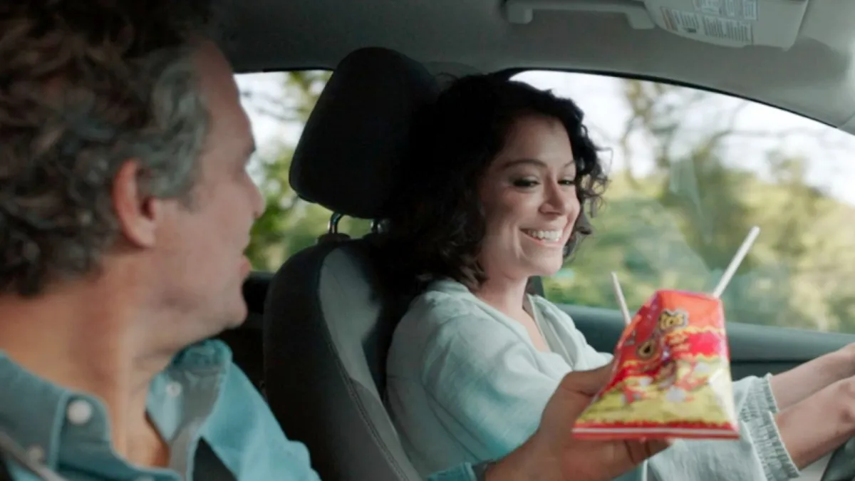 Mark Ruffalo as Bruce Banner and Tatiana Maslany as Jennifer Walters in a still from “She-Hulk: Attorney at Law,” seated in a car where Jennifer is eating Cheetos with chopsticks