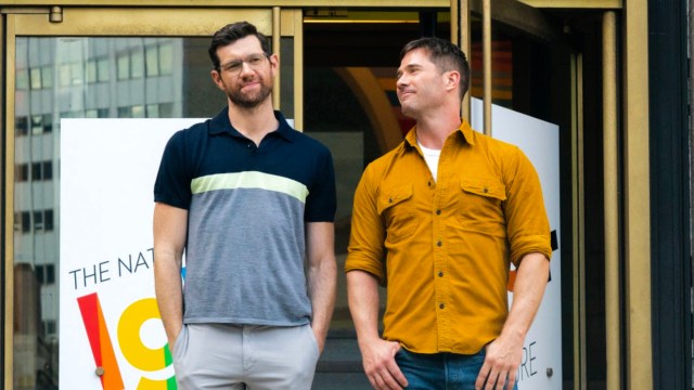 Luke Macfarlane gazes at Billy Eichner outside of a gas station on the set of Bros