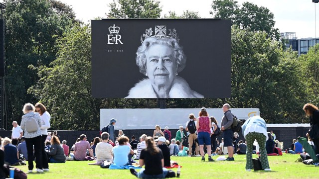 Mourners gather to watch the procession for the Lying-in State of Queen Elizabeth II at the Hyde Park screening site on September 14, 2022 in London, England. Queen Elizabeth II's coffin is taken in procession on a Gun Carriage of The King's Troop Royal Horse Artillery from Buckingham Palace to Westminster Hall where she will lay in state until the early morning of her funeral. Queen Elizabeth II died at Balmoral Castle in Scotland on September 8, 2022, and is succeeded by her eldest son, King Charles III.