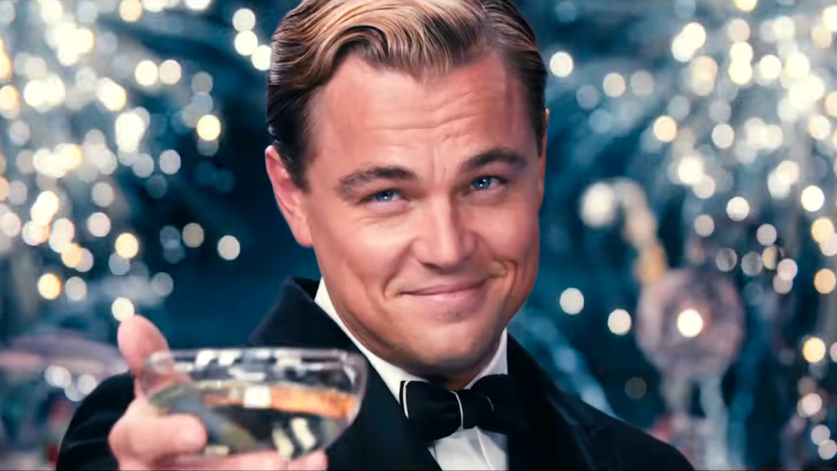 Leonardo DiCaprio as Gatsby raising a toast in The Great Gatsby