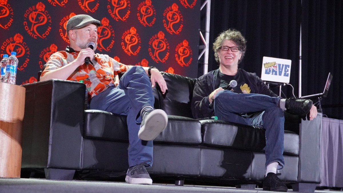 Sean Schemmel and Christopher Sabat host a panel at a comic con event.