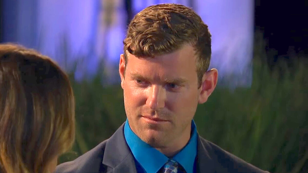 James McCoy Taylor wearing a black suit and blue tie on The Bachelorette