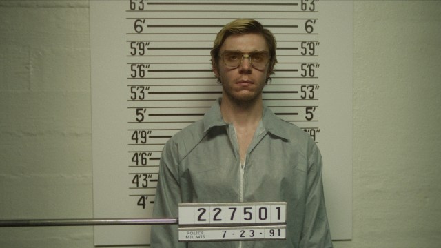 Evan Peters as Jeffrey Dahmer poses for a mugshot