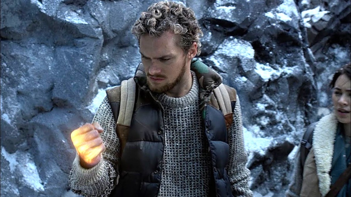 Danny Rand (Finn Jones) wields a glowing fist while stalking through a snowy mountain range in Iron Fist