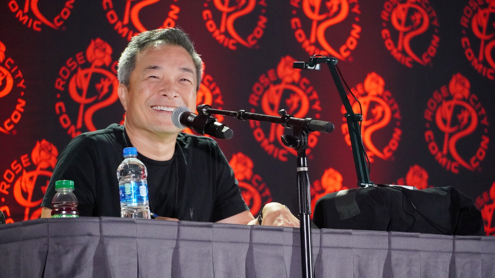 Jim Lee hosts a panel at a comic con event.