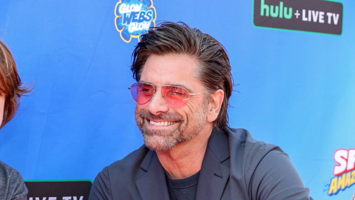 John Stamos wears pink sunglasses at Disney Junior's "Marvel's Spidey and His Amazing Friends" VIP event at Santa Monica Pier on August 27, 2022 in Santa Monica, California.