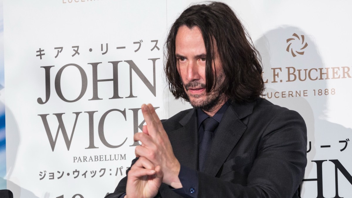 Keanu Reeves make a karate pose with his hands at the red carpet event for 'John Wick 3' in Tokyo, Japan.