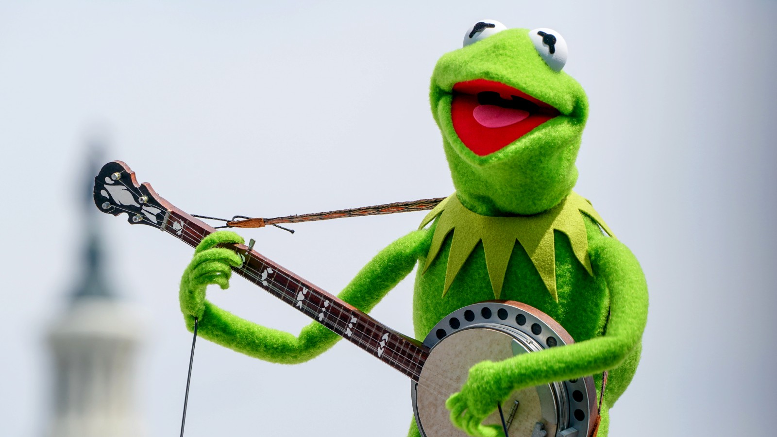 Kermit the Frog plays a banjo.