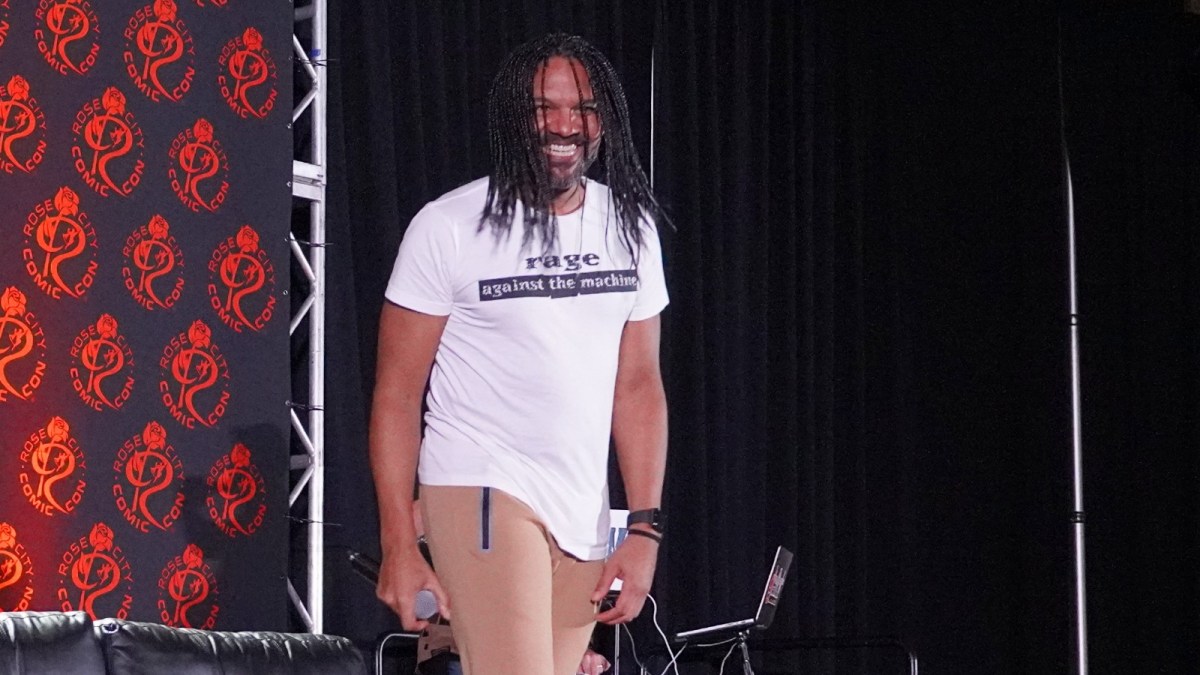 Khary Payton fields fan questions at a comic con panel.