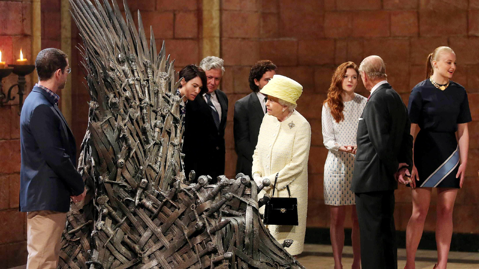  Queen Elizabeth II meets cast members of the HBO TV series 'Game of Thrones' Lena Headey and Conleth Hill while Prince Philip, Duke of Edinburgh shakes hands with Rose Leslie as they views some of the props including the Iron Throne on set in Belfast's Titanic Quarter on June 24, 2014 in Belfast, Northern Ireland.