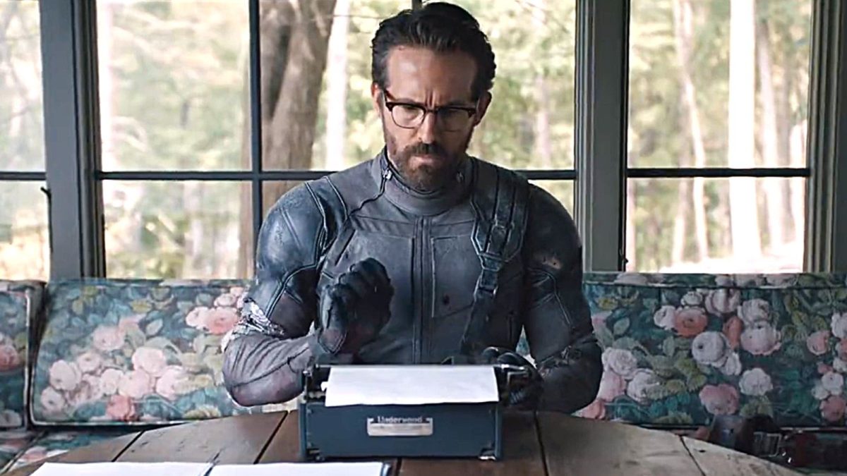 ryan reynolds deadpool 3 teaser wearing his gray Deadpool 2 suit and typing on a typewriter