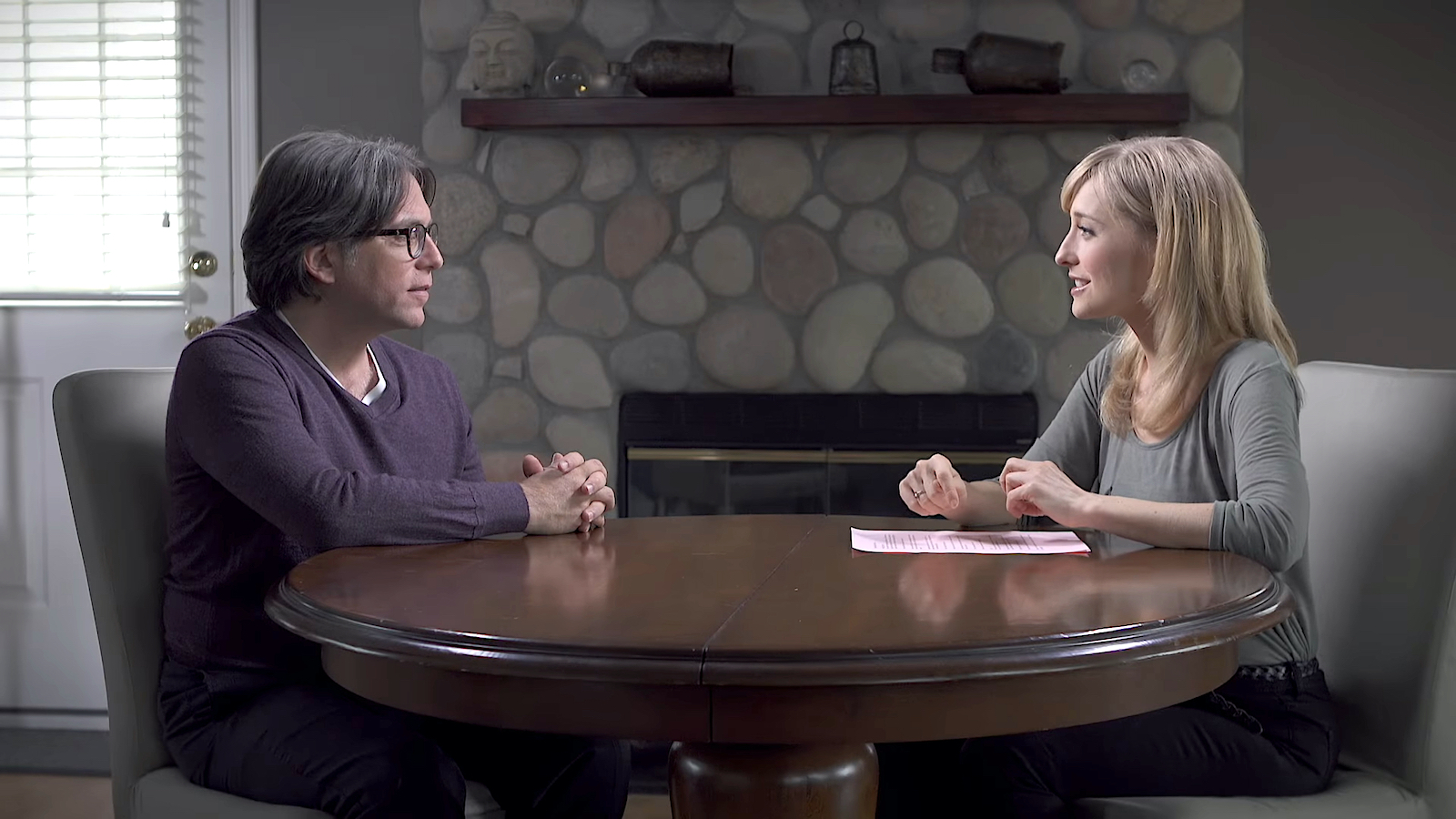 Allison Mack sitting across from NXIVM cult leader Keith Raniere