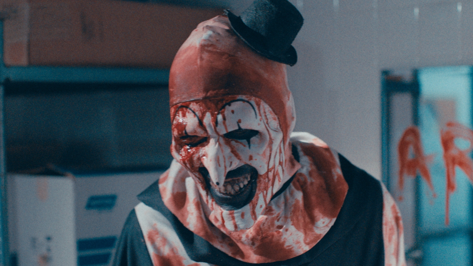 Art the Clown in Terrifier 2 is covered in blood. 